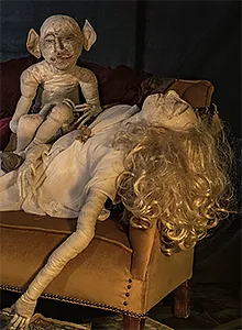 Small view of a demon sitting on a sleeping woman.
