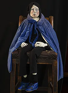 Human sculpture of a man in blue cloak