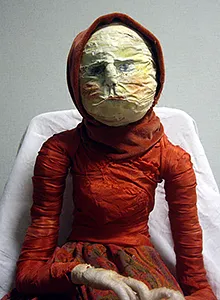 Human sculpture a woman in red.
