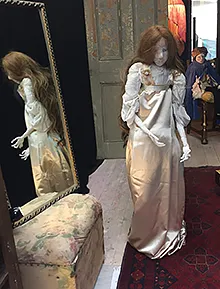 Small view of installation with woman figure in foreground.
