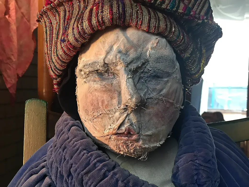 Close of man sculpture who sits in the background.