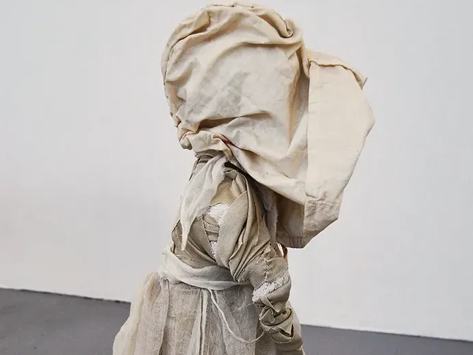 The girl offside wrapped in heavy clothes.