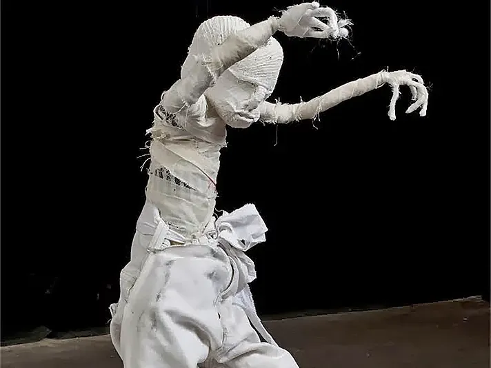 A boy in a dancing pose.