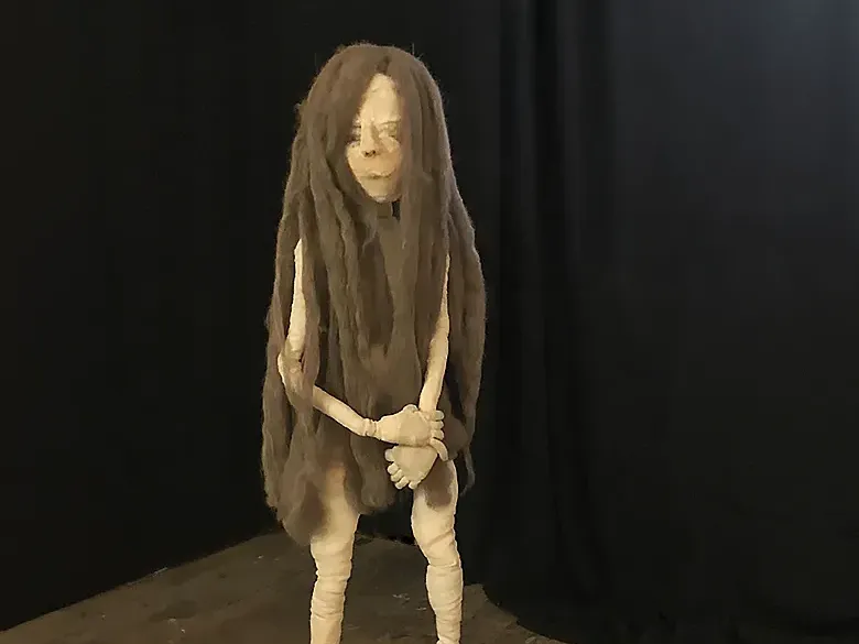 Girl standing in one corner of the room.