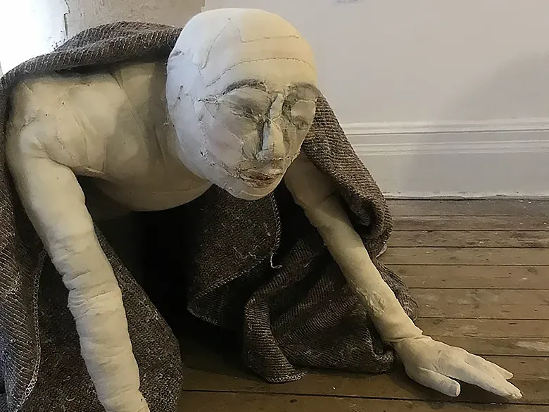 The crawling woman close-up in the other corner of the room.
