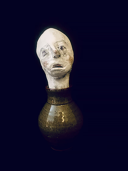 Head sculpture emerging from a ceramic pot